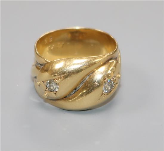 A George V 18ct gold and diamond set twin serpent ring, size P.